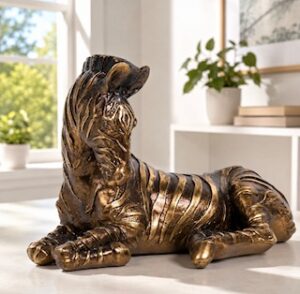 Zebra ornament in bronze colour lying down in a room