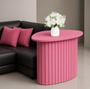 OHS ribbed side table in the colour hot pink by a sofa