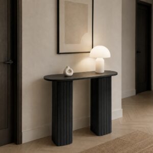 Ribbed console table in black with lamp and ornament on in the hall