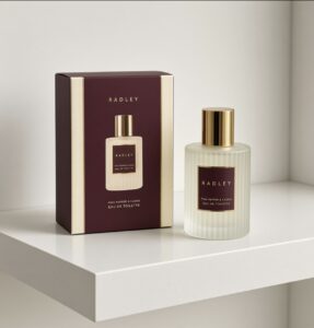 A bottle of Radley pink cassis perfume with the box on a white gloss shelf