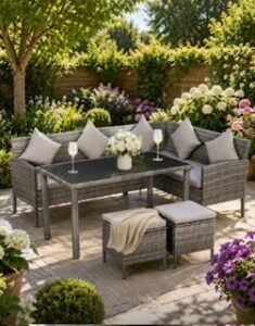 Rattan corner sofa with coffee table and 2 cube stools set in the garden