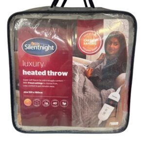Silentnight Luxury Heated Throw in its wrappers with a woman sitting up with the throw over her legs