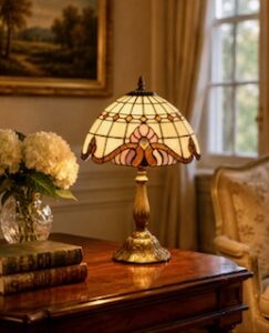 A Tiffany antique classic lamp lit up on a table in a room