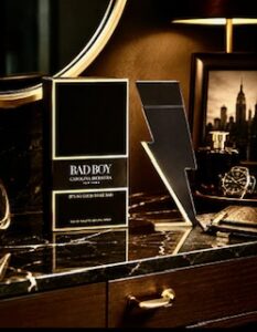 A bottle of Carolina Herrera aftershave called Bad Boy on a gents dresser