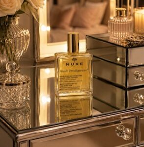 Bottle of Nuxe huile prodigieuse on a dressing table