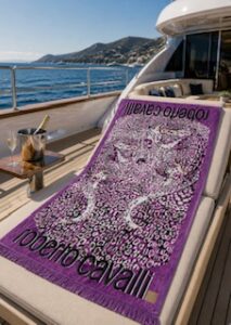 Roberto Cavalli Leo Camouflage beach towel on a deck chair on a yacht